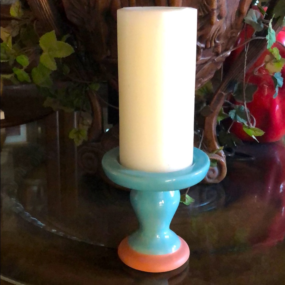 White candle with turquoise pedestal